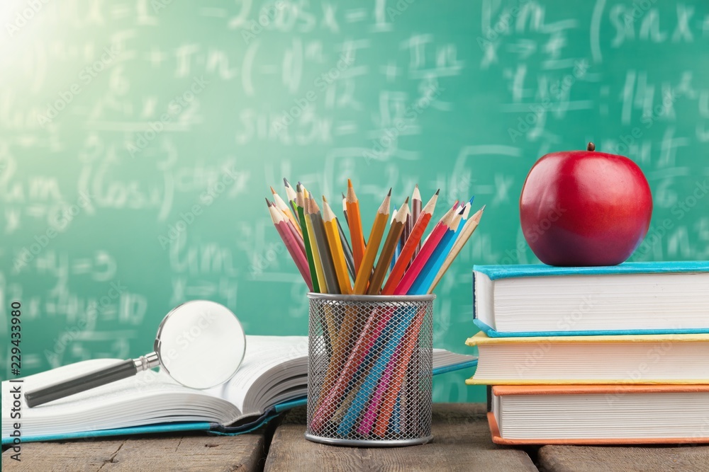 School supplies - books and pencils isolated on background School supplies - books and pencils isolated on background
