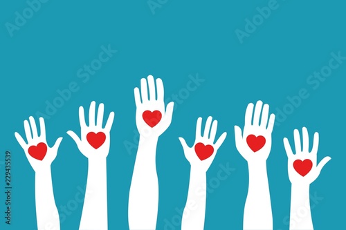 Raised hands holding giving red color hearts