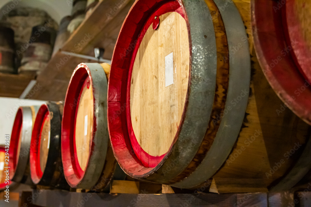 Wooden wine barrels in a very old basement. 