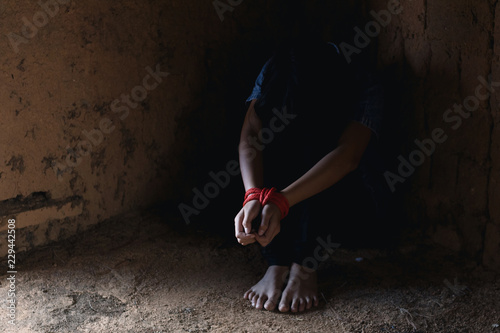 Kidnapped little girl tied with rope.Abused and tortured concept. Human trafficking concept. Stop violence against Women. International women's Day. Stop abusing violence.