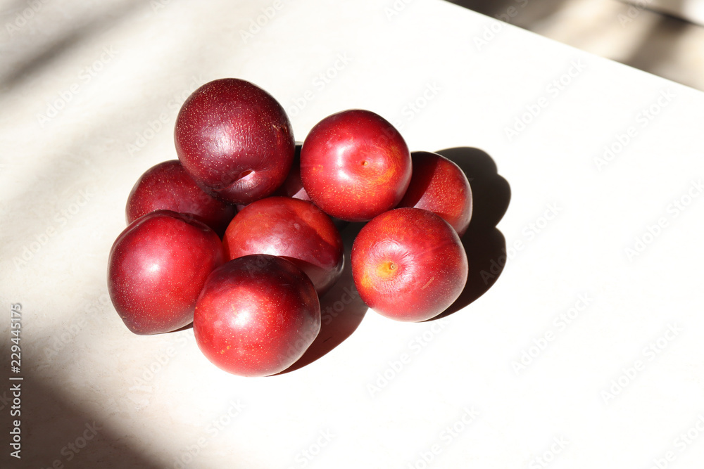 Plums on a modeled stone countertop Plums on a modeled stone countertop