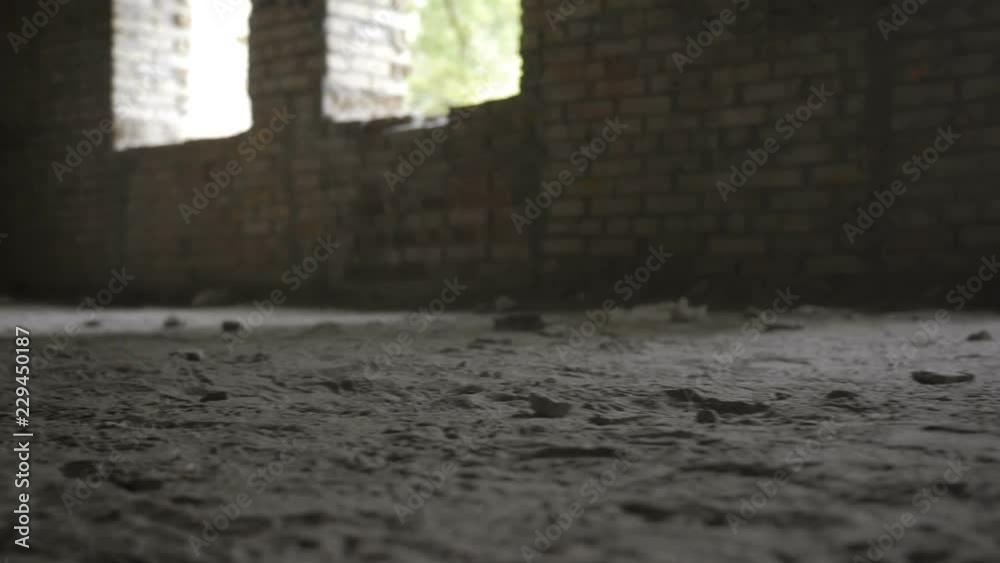 Close-up of army soldiers legs in old paratrooper boots running through dusty ruined building during military operation. Squad fully equipped and armed soldiers running forward and attacking enemy.