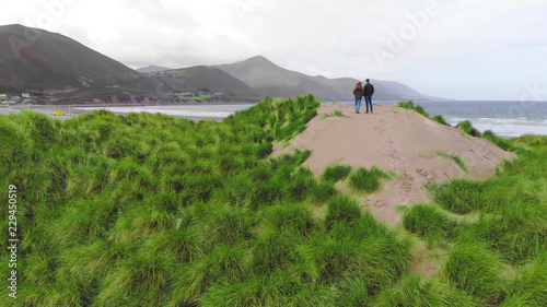 Young couple at the Irish coat – enjoying the view over the ocean