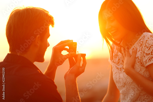 Successful marriage proposal at sunset photo