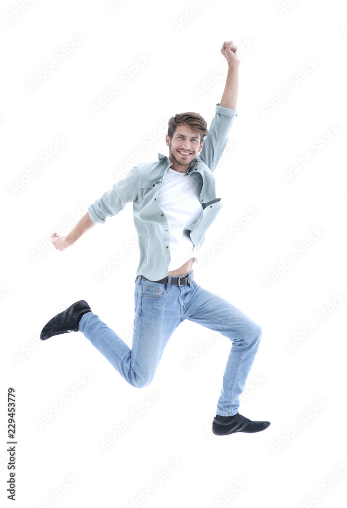 Happy man jumping in air over white background