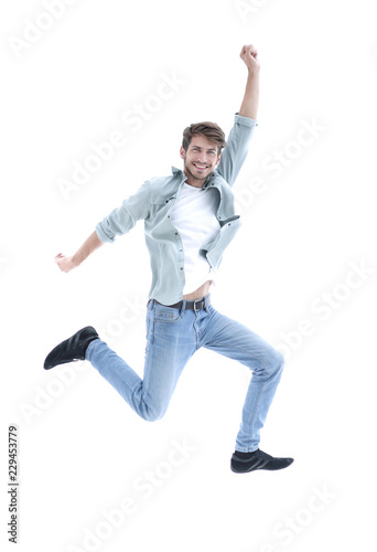 Happy man jumping in air over white background