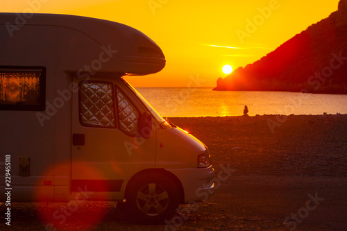 Camper car on nature at sunrise. Travel