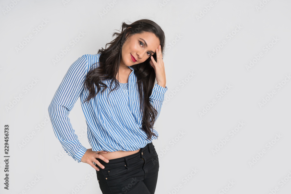 Woman with body expression, with hand in the head with head tilted to one sido with other hand in waist Woman with body expression, with hand in the head with head tilted to one sido with other hand in waist