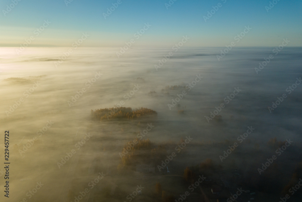 drone image. aerial view of rural area with sun halo above mist drone image. aerial view of rural area with sun halo above mist