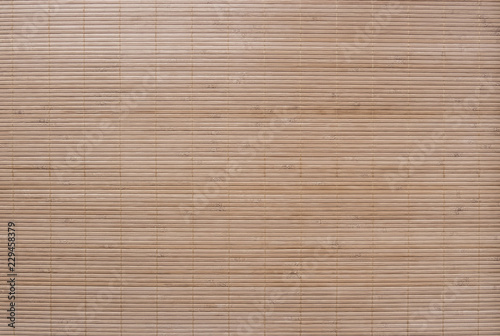 Textured background from bamboo table cloth. Very large seamless texture of wooden material.