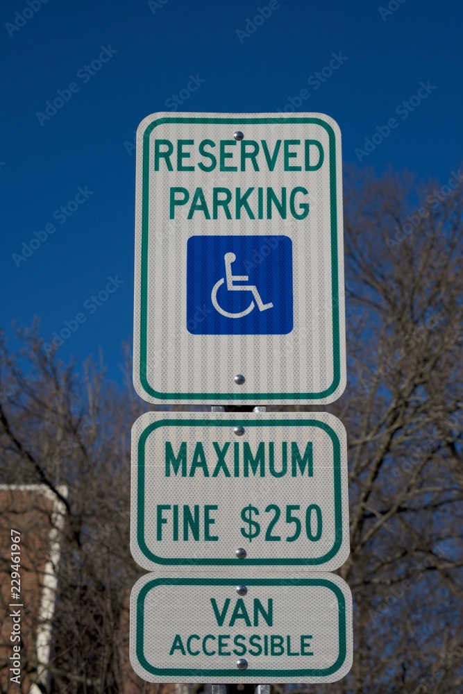 RESERVED PARKING SING FOR HANDICAPPED WITH $ 250 FINE .