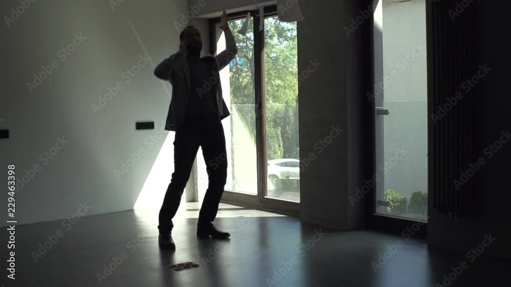 Angry man talking on cellphone throwing documents at new home, slow motion Angry man talking on cellphone throwing documents at new home, slow motion
