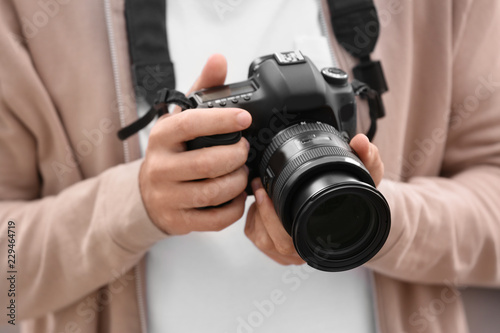Male photographer with professional camera, closeup view