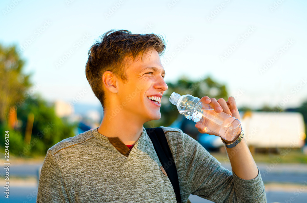Teenage Boy Squirting Water Into His Mouth Stock Photo - Download Image Now  - Adolescence, Bottle, Drink - iStock