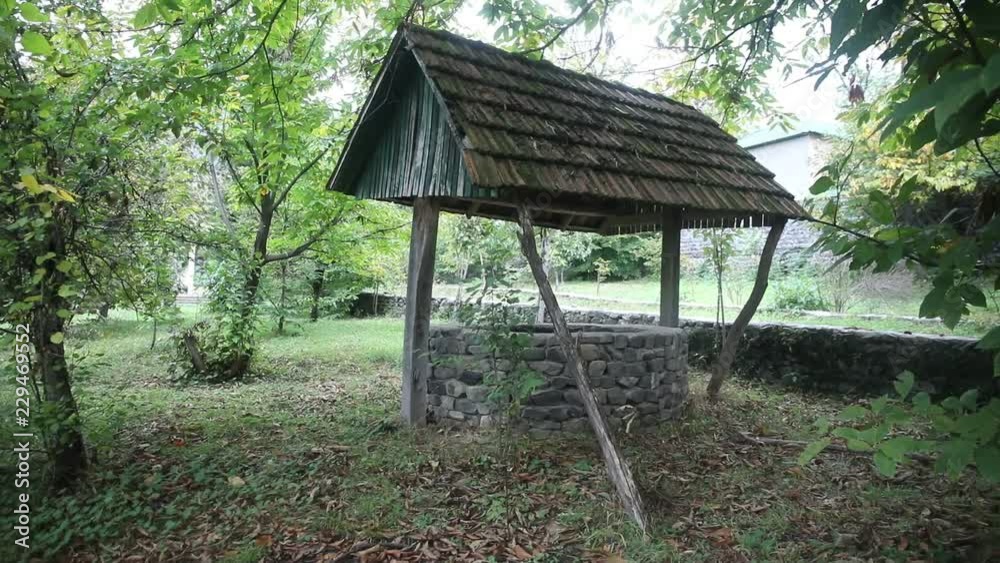Abandoned well in the forest. Waiting for a terrible girl with a long hair. Halloween concept. Slider shot