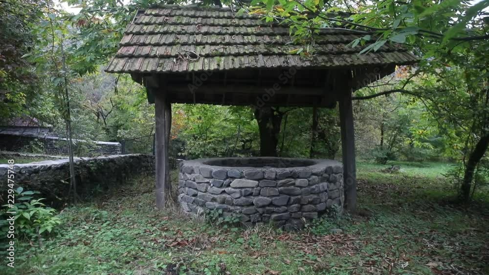 Abandoned well in the forest. Waiting for a terrible girl with a long hair. Halloween concept. Slider shot Abandoned well in the forest. Waiting for a terrible girl with a long hair. Halloween concept. Slider shot