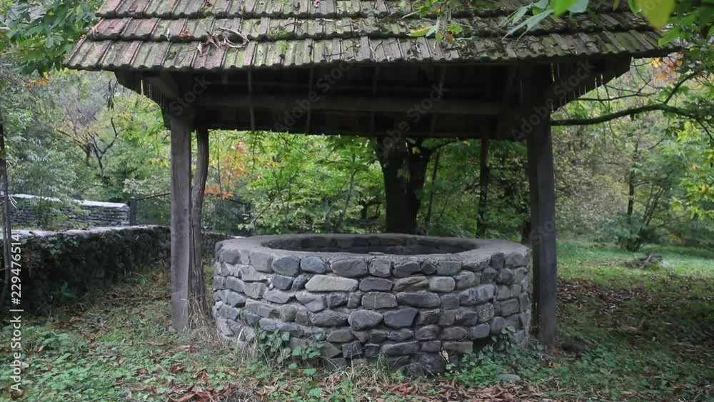 Abandoned well in the forest. Waiting for a terrible girl with a long hair. Halloween concept. Slider shot Abandoned well in the forest. Waiting for a terrible girl with a long hair. Halloween concept. Slider shot