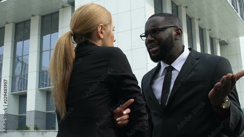 Woman giving slap to african-american colleague, violation of individuals rights Woman giving slap to african-american colleague, violation of individuals rights