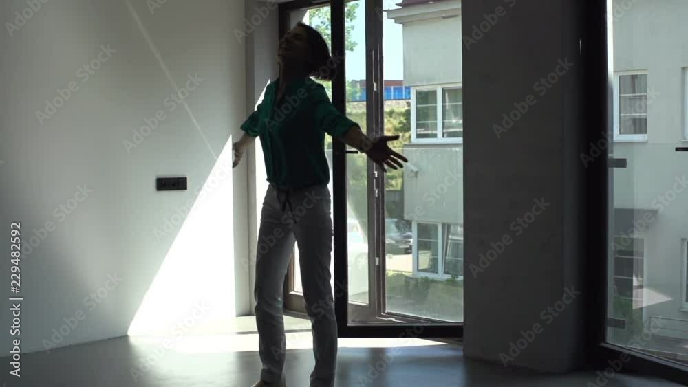 Happy young excited woman at her new home, super slow motion Happy young excited woman at her new home, super slow motion