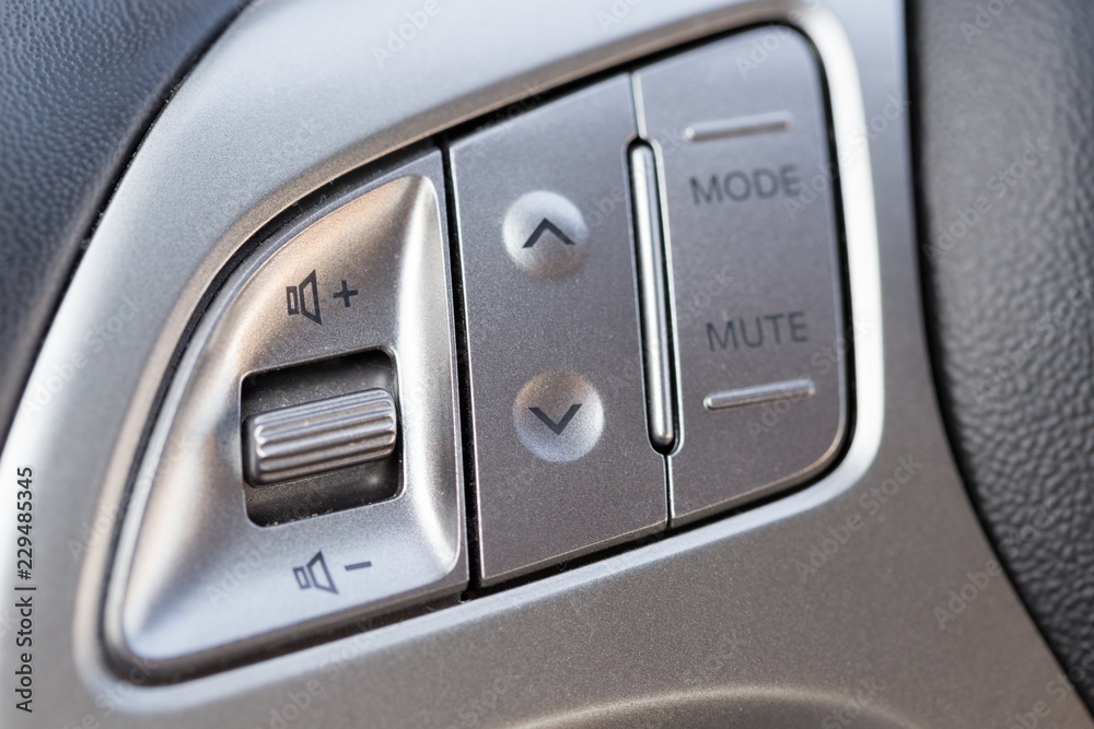 Closeup of Audio Control Buttons on the Steering Wheel of Car