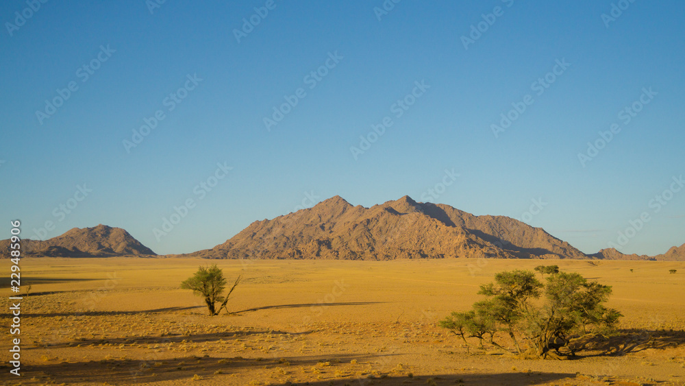 landscape with mountains and blue sky in Namibia desert