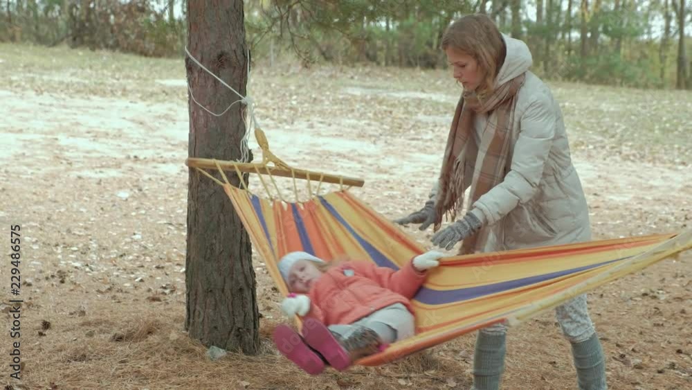Adorable baby sit in hammock under trees Adorable baby sit in hammock under trees