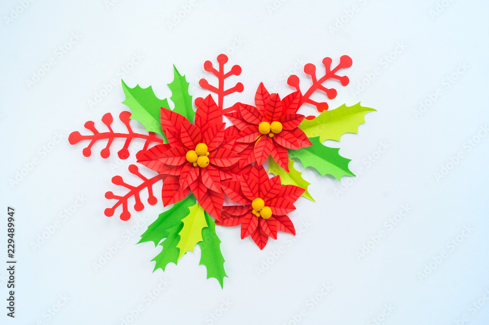 Fototapeta premium Paper flower poinsettia and leaves of holly
