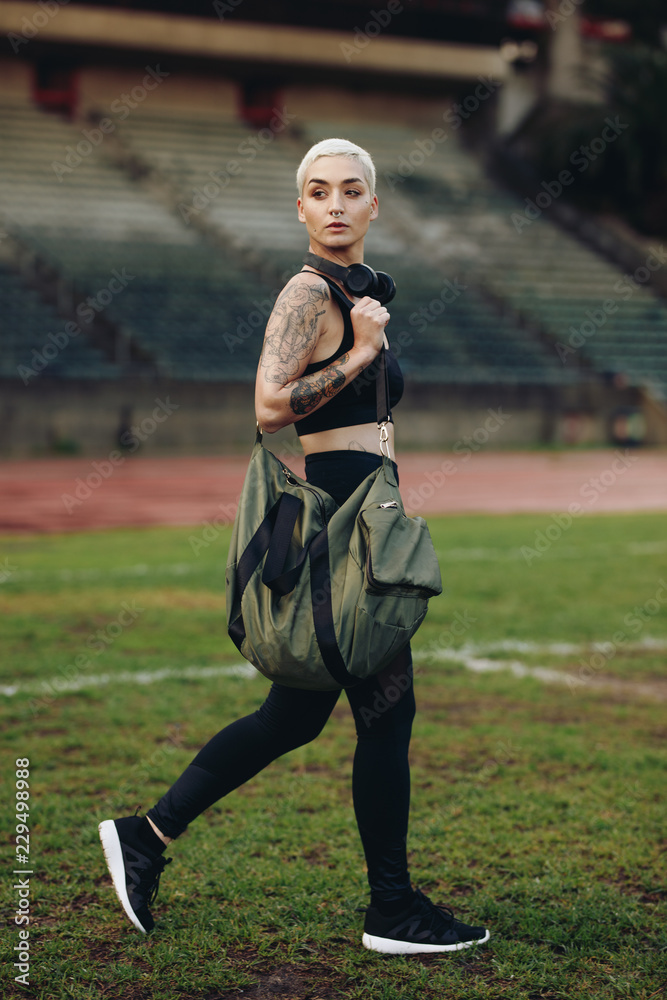 Obraz premium Fitness woman walking inside a track and field ground