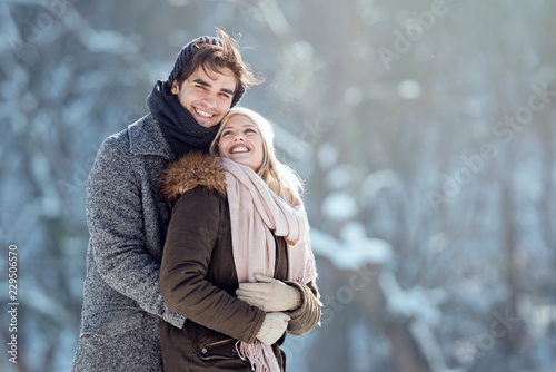 Two young people enjoying in the snow photo