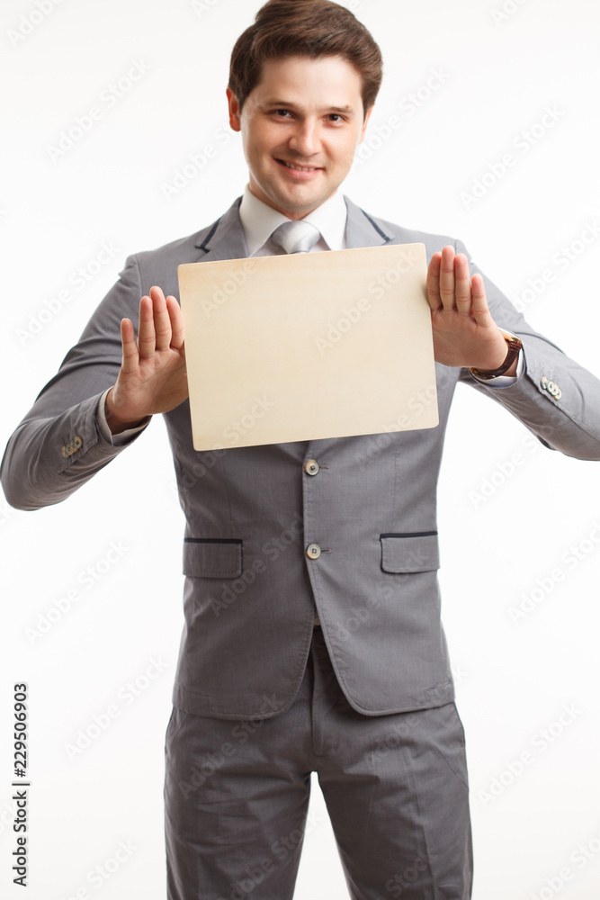 Businessman showing signboard. In studio on a white background Businessman showing signboard. In studio on a white background