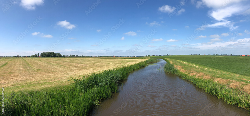 Panorama from farmland and a canal