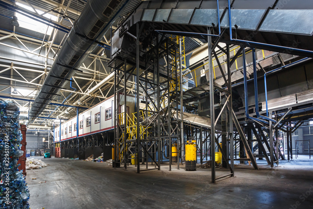 metal constructions of garbage sorting conveyor on modern waste recycling processing plant. Separate garbage collection. Storage of waste for further disposal. metal constructions of garbage sorting conveyor on modern waste recycling processing plant. Separate garbage collection. Storage of waste for further disposal.