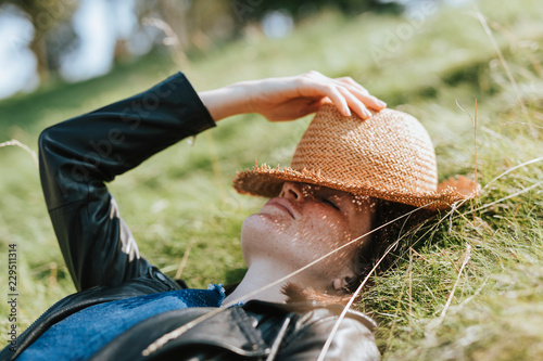Woman taking a nap on the grass photo