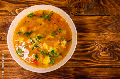 Georgian traditional food soup kharcho on wooden table. Top view