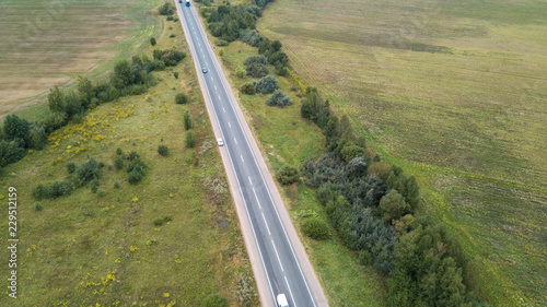 Aerial view of a road in a green field