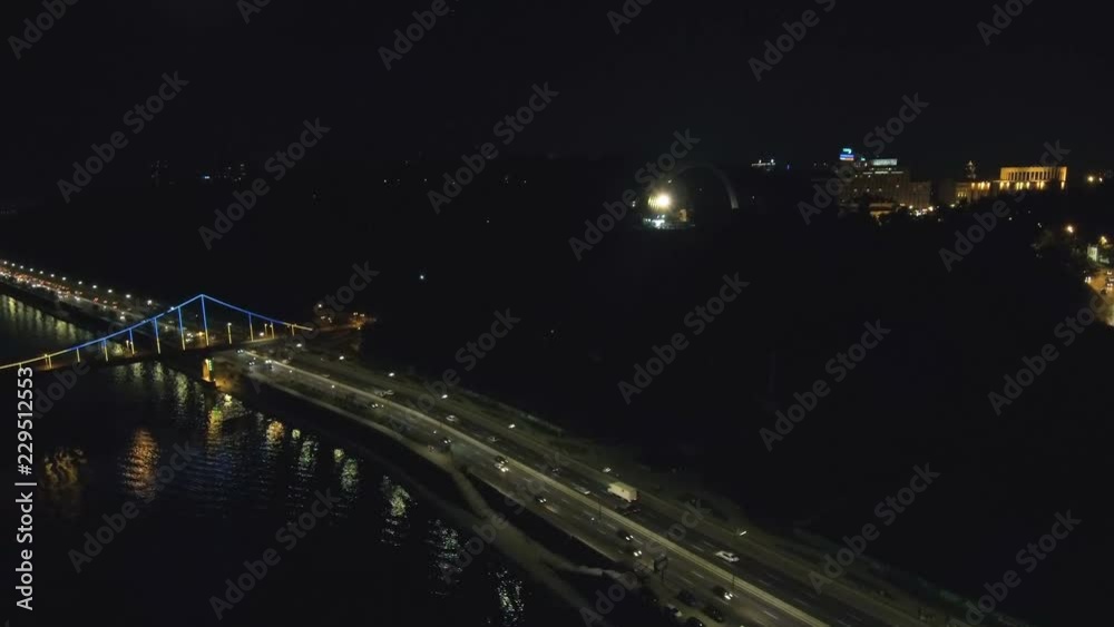 Aerial view from Drone: Top view of the night promenade with bridges and cars. Driving with headlights on the road. Aerial view from Drone: Top view of the night promenade with bridges and cars. Driving with headlights on the road.