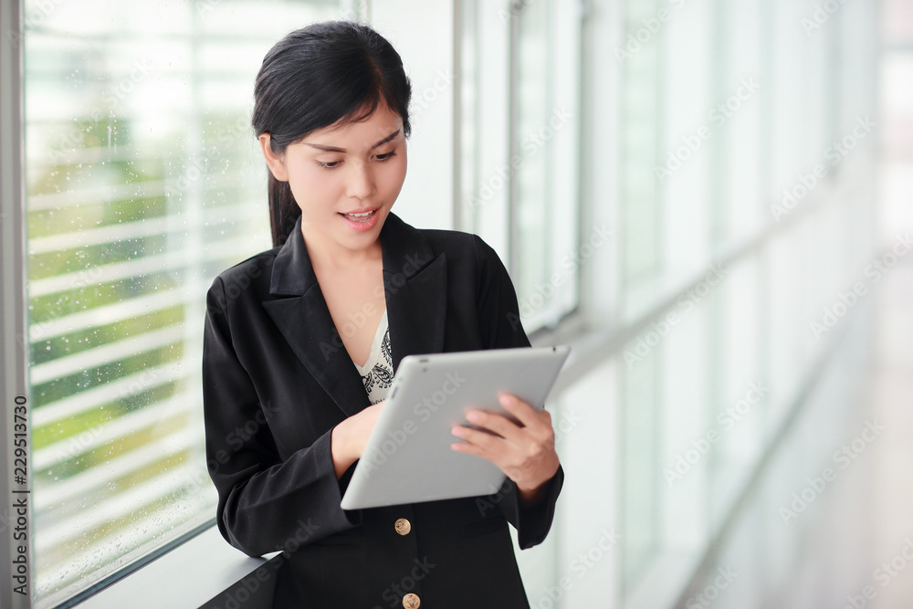 beautiful businesswoman portrait using tablet (this image for business and technology background concept) beautiful businesswoman portrait using tablet (this image for business and technology background concept)