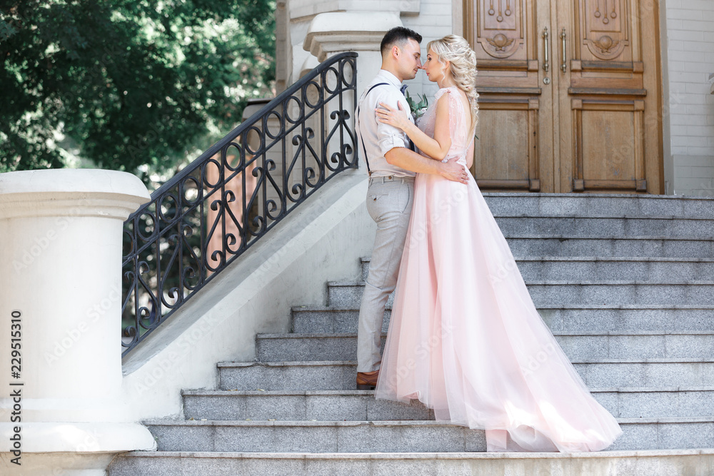 Fototapeta premium wedding couple in city in sunny summer day.