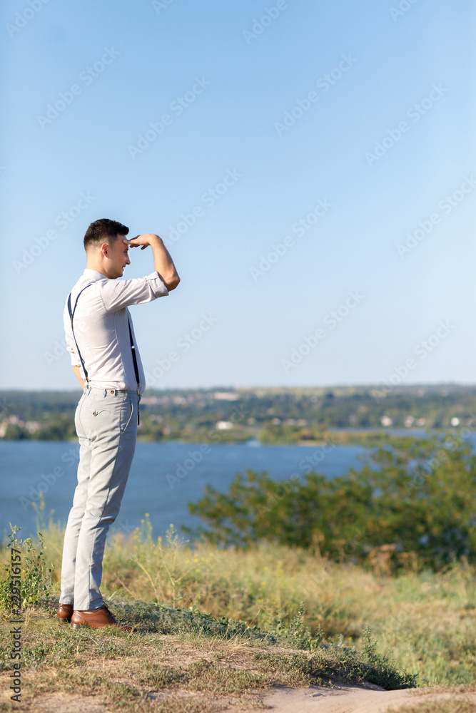 Portrait of a young handsome groom outdoors at sunset. Portrait of a young handsome groom outdoors at sunset.
