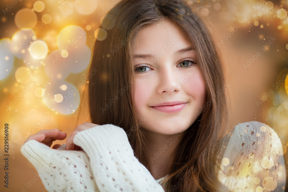 Fototapeta premium Portrait of beautiful girl with long hair wearing warm winter clothes in Christmas interior.