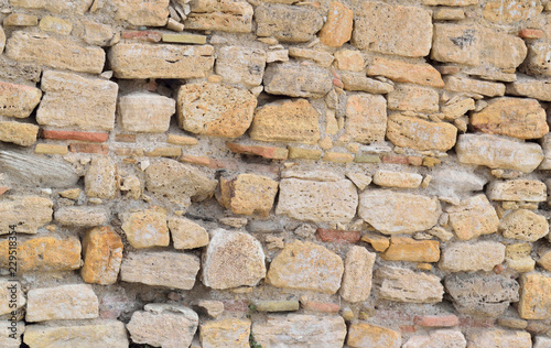 large natural stones stacked in a stone wall background