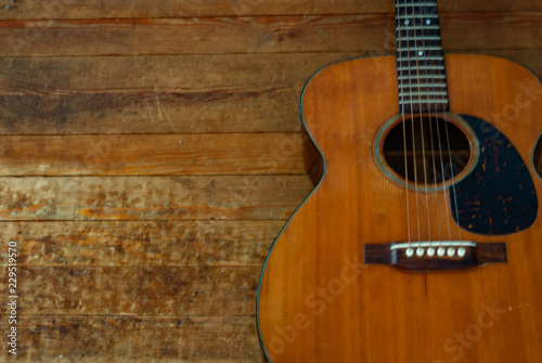 Vintage Acoustic Guitar on a Hardwood Floor.
