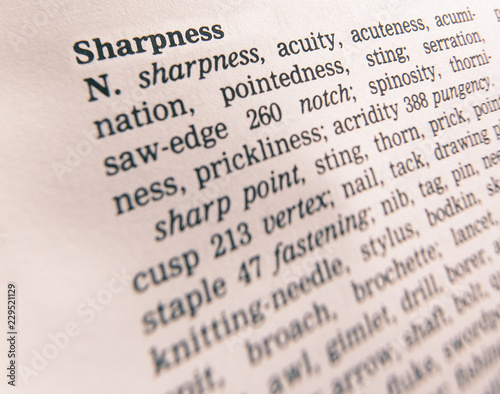 CLOSE UP OF DICTIONARY PAGE SHOWING DEFINITION OF THE WORD SHARPNESS