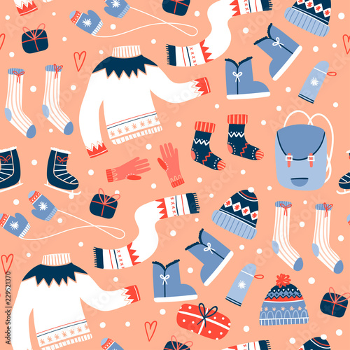 Cozy winter clothes and other stuff. Colored vector seamless pattern. Peach background