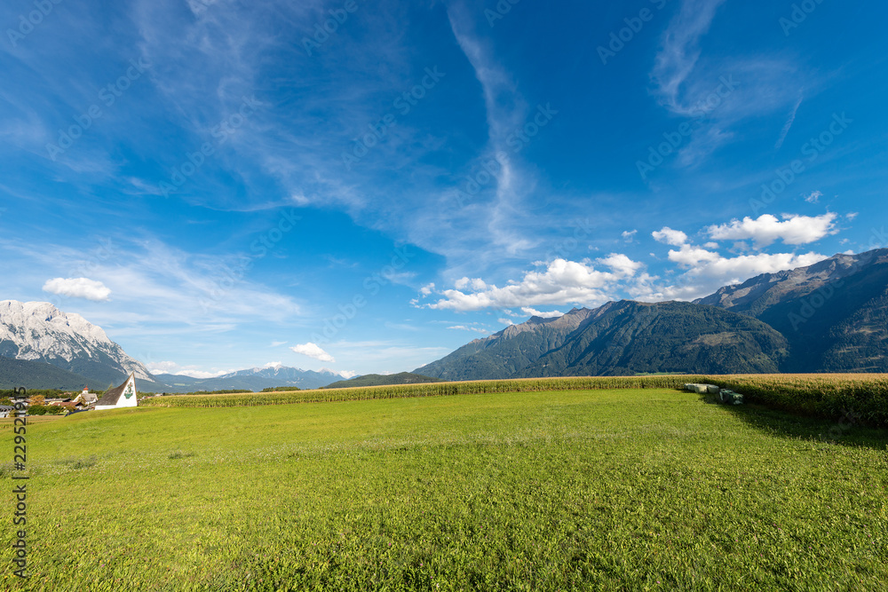 Austrian Alps with Corn Fields and Meadows.