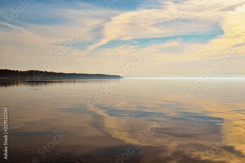 Panoramic dramatic sunset sky. Clouds reflected in the Dnieper River near the Kyiv city, Ukraine. Concept of landscape and nature