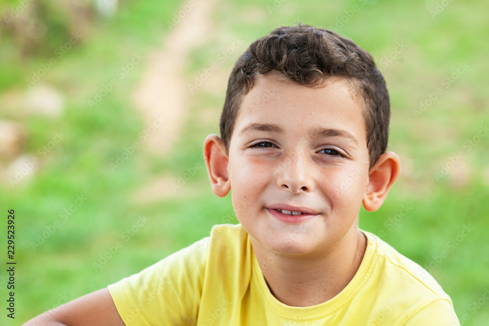 Portrait of happy smiling child boy outdoors. Concept of happy family or successful adoption or parenting. Portrait of happy smiling child boy outdoors. Concept of happy family or successful adoption or parenting.