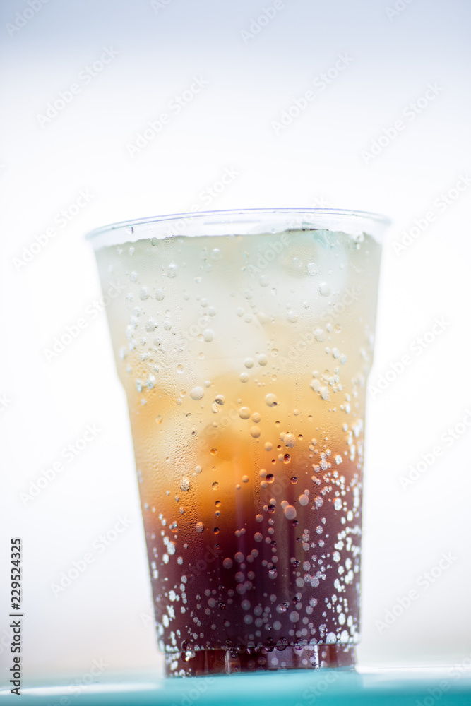 A glass of water, a close-up view of cold ice, a glass of soft drinks (soft drinks, alcohol, nectar) placed on a wooden table, managed by the client or eaten to refresh the body. A glass of water, a close-up view of cold ice, a glass of soft drinks (soft drinks, alcohol, nectar) placed on a wooden table, managed by the client or eaten to refresh the body.