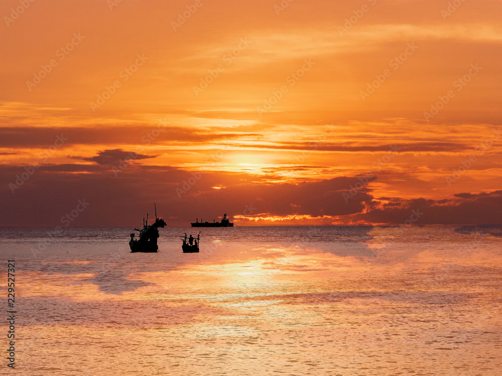 Sunset,Sky and sea with boat silhouette at koh larn in chonburi province of thailand