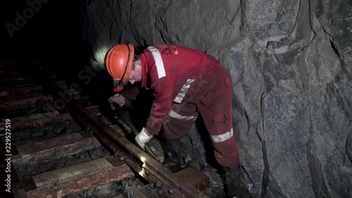 Railway workers bolting track rail. Repair rail